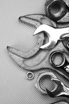 Some wrenches and nuts black and white