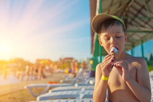 Baby boy with ice-cream at the beach