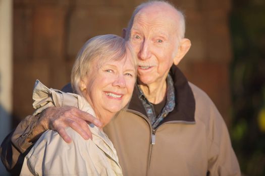 Cute senior couple embracing each other outdoors