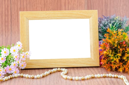 Blank wooden photo frame and flower on wooden background. save clipping path.