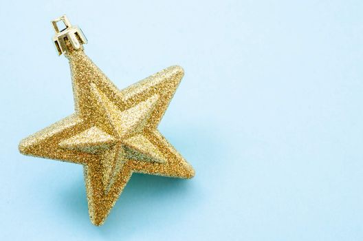 Golden Christmas star on blue background