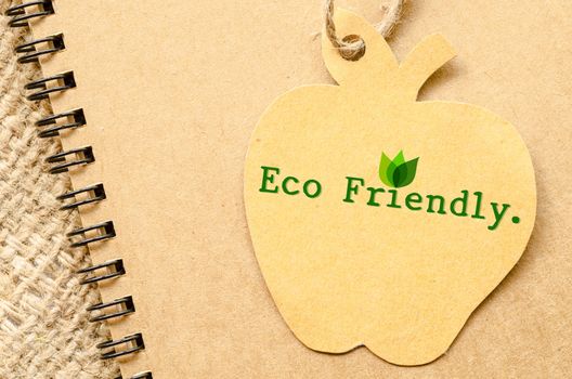 Eco friendly on brown recycle paper and diary on sack background.