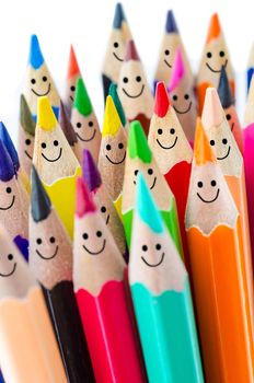 Colorful pencils as smiling faces people on white background.
