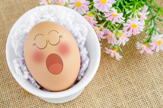 Eggs sleep in Expression Face with flower on sack background.