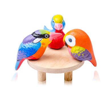 Bird toy ceramic and wooden table on white background.