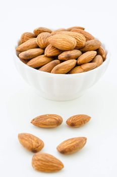Almond in white cup on white background.
