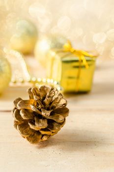 Gold Christmas decorations with light bokeh background.