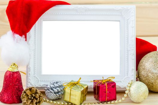 Vintage photo frame and christmas decorations on wood background. Save clipping path.
