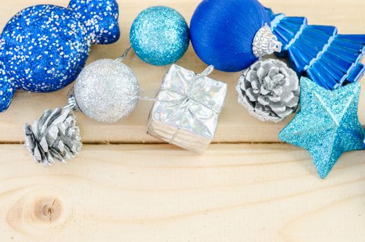 Blue christmas decorations on wooden background.