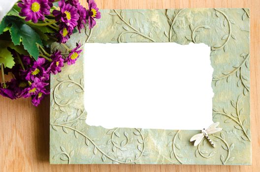 Blank photo frame and pink rose on wooden background. save clipping path.