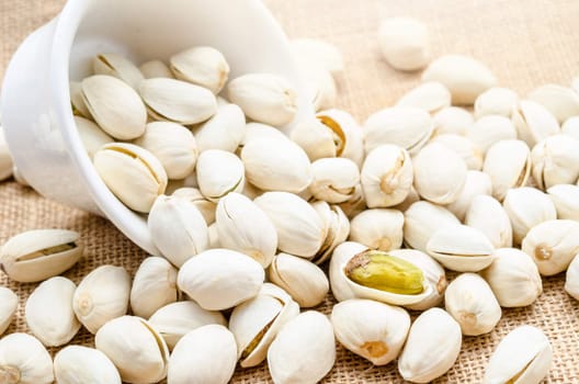 close up of a bowl of pistachio nuts.