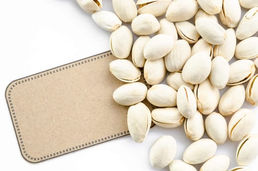 Natural Pistachio nuts and brown tag on white background.