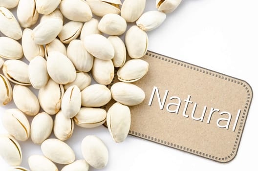 Natural Pistachio nuts and brown tag on white background.