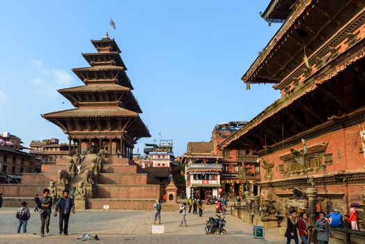 BHAKTAPUR, NEPAL - NOVEMBER 15, 2015: Taumadhi square with Nyatapola temple on the left and  Bhairavnath temple on the right.