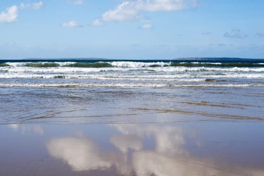 beautiful soft waves break on the sandy beach at ballybunion