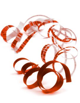 Arrangement of Dark Red and Striped Curled Party Streamers Lying on white background