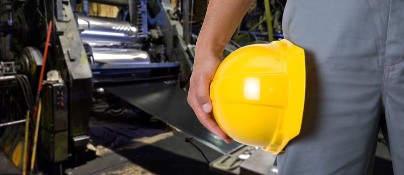 Worker with safety helmet at industrial factory