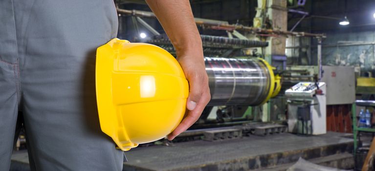 Worker with safety helmet at industrial factory