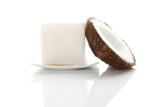 Coconut oil. Hard coconut oil and coconut isolated on white background with reflection. Healthy eating and cooking. 