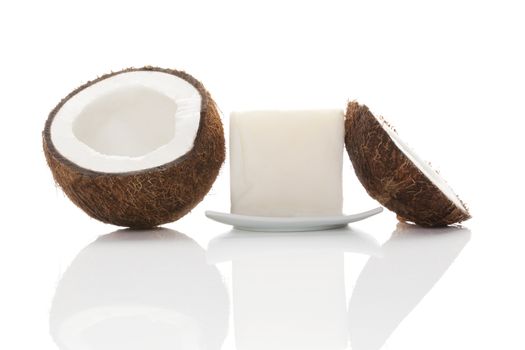 Coconut oil. Hard coconut oil and coconut isolated on white background with reflection. Healthy eating and cooking. 