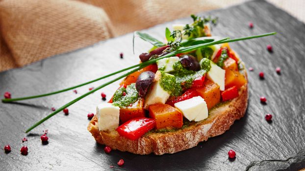 Bruschetta with roasted pumpkin, red pepper,pesto and cheese