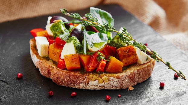 Bruschetta with roasted pumpkin, red pepper,pesto and cheese