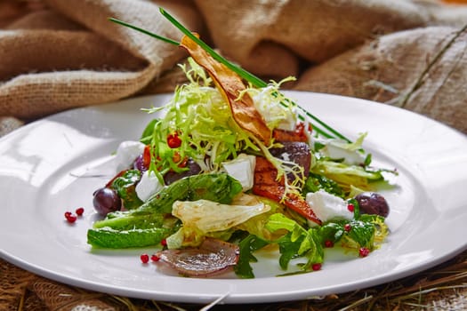 Fresh spring salad with feta cheese, red onion in white bowl. background with free text space.