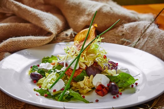 Fresh spring salad with feta cheese, red onion in white bowl. background with free text space.