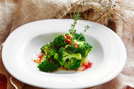 boiled broccoli in white bowl on table