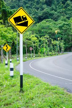 Steep grade hill traffic sign on road into the mountain.