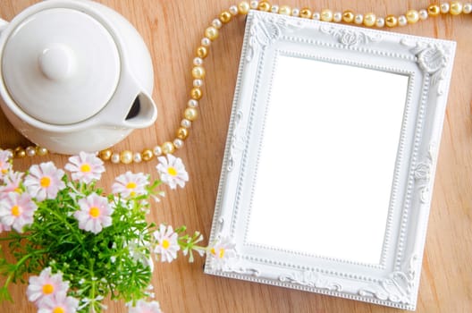 Blank photo frame and flower on wooden background, save clipping path.