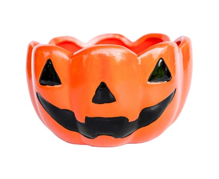 A ceramic cup with pumpkin halloween face shape isolated on white background, clipping path.