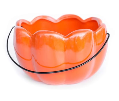 Orange color ceramic pumpkin shape basket on white background.