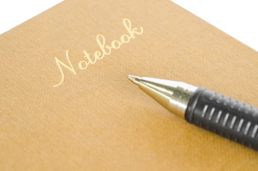 Focus gold color Note book with pen on white background.