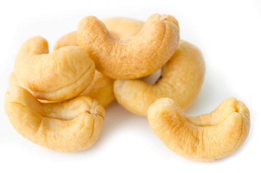 cashews nuts in closeup on white background.