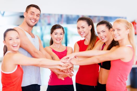 fitness, sport, training and lifestyle concept - group of happy people in the gym celebrating victory