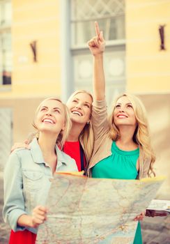 holidays and tourism concept - beautiful blonde women with tourist map in the city