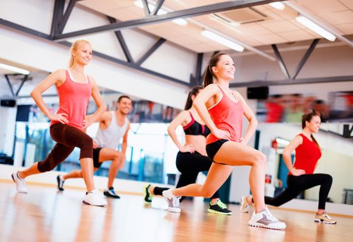 fitness, sport, training, gym and lifestyle concept - group of smiling people exercising in the gym