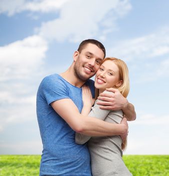 love and family concept - smiling couple hugging