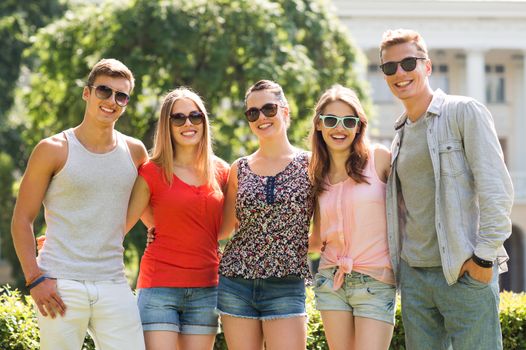 friendship, leisure, summer and people concept - group of smiling friends outdoors