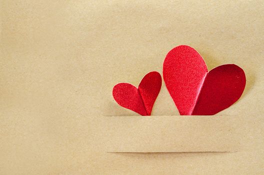Red heart on vintage brown paper background with copyspace