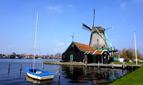 Windmills and river and boat in holland