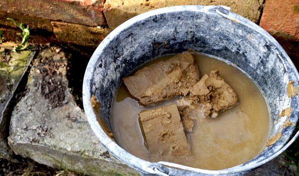 clay brick in water bucket                                