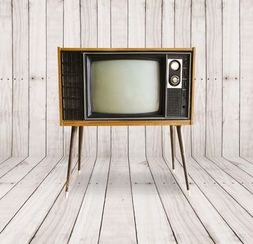 old vintage television on wood background.