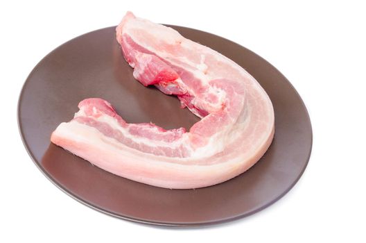 Raw bacon in brown dish on white background.