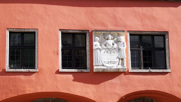 old rose color facade and sculpture in old town Innsbruck