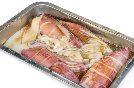 Preparation of raw squid and ingredients , ready to grill