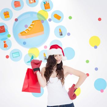 Beauty brunette in boxing gloves with shopping bag against dot pattern