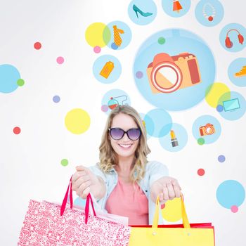 Woman holding some shopping bags against dot pattern