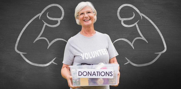 Happy grandmother holding donation box against black background